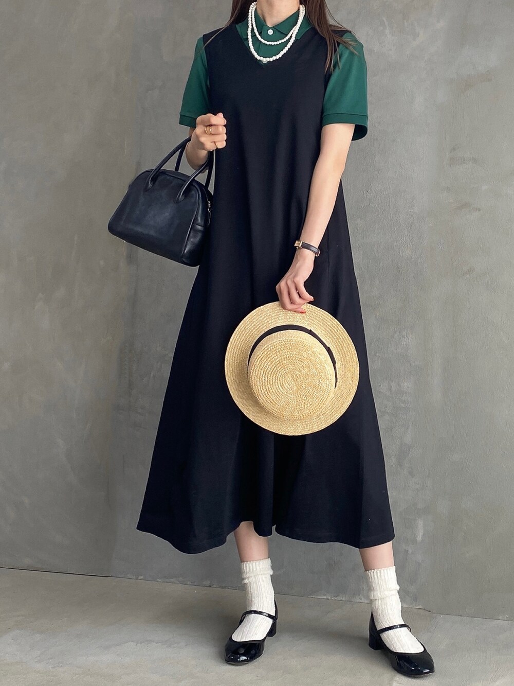 ブラック系のボストンバッグ、ブラック系のワンピース/ドレス、ブラック系のパンプスを着用したレディースの夏コーディネートの2枚目の写真