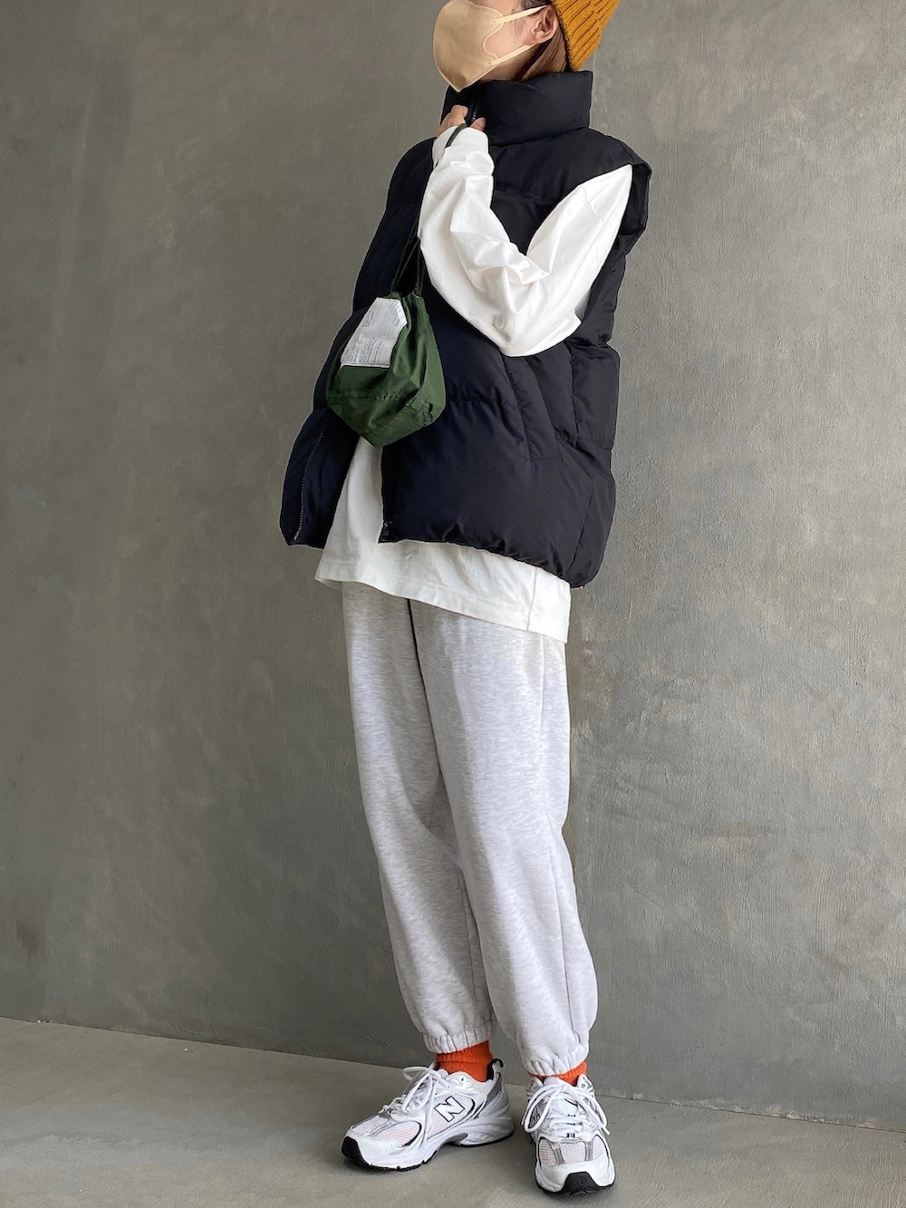 ホワイト系のスニーカー、グレー系のスウェットパンツ、ブラック系のジャケット/アウターを着用したレディースの秋コーディネートの2枚目の写真