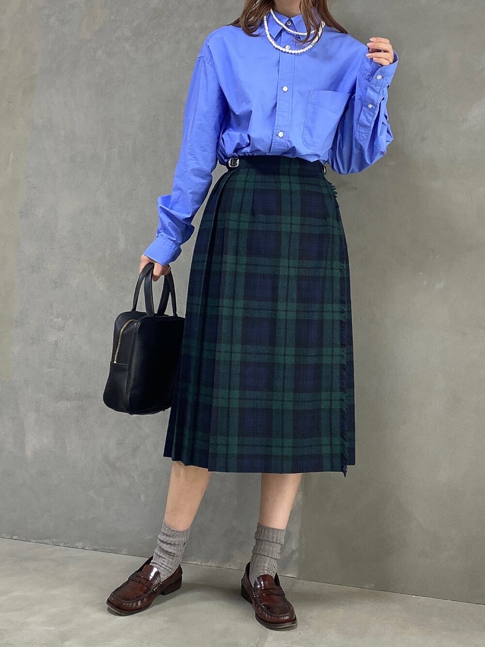 ブルー系のシャツ/ブラウス、ブラック系のハンドバッグ、ブラック系のスカートを着用したレディースの春コーディネートの3枚目の写真