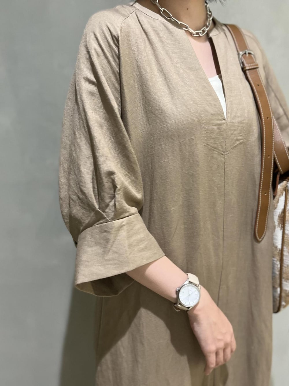 ベージュ系のワンピース、ホワイト系のサンダル、ホワイト系のタンクトップを着用したレディースの夏コーディネートの2枚目の写真