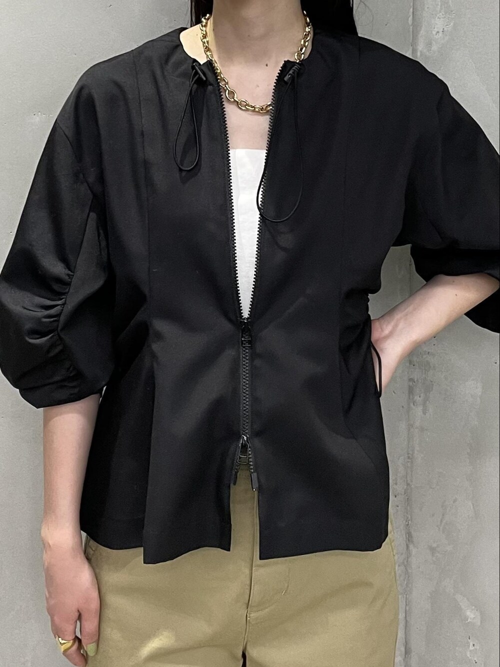 ベージュ系のチノパンツ、ホワイト系のキャミソール、ブラック系のシャツ/ブラウスを着用したレディースの夏コーディネートの3枚目の写真