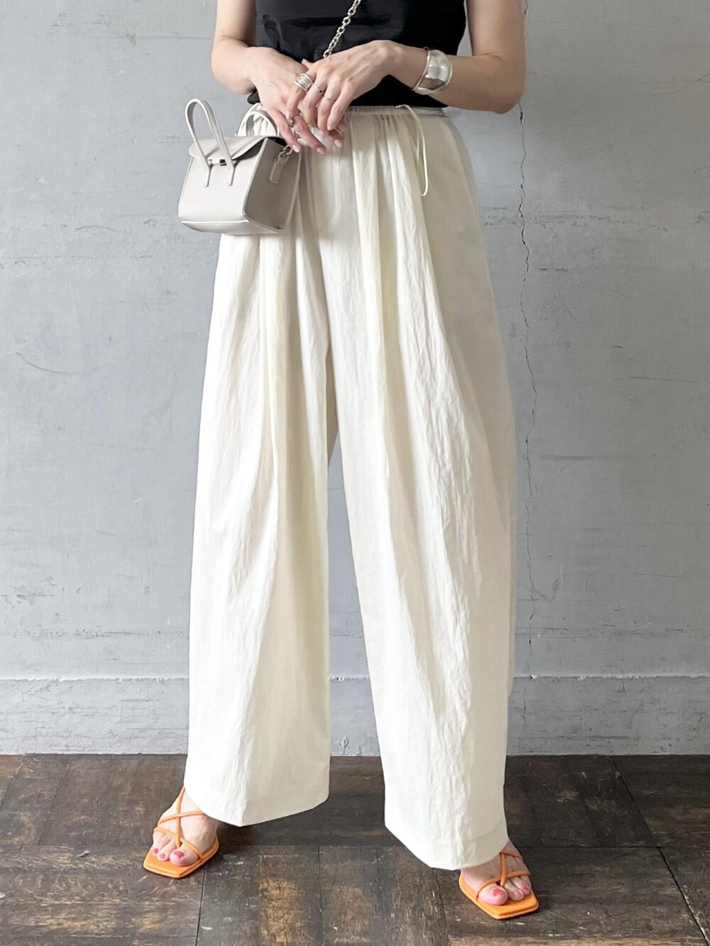 ブラック系のタンクトップ、グレー系のショルダーバッグ、ホワイト系のその他パンツを着用したレディースの夏コーディネートの5枚目の写真