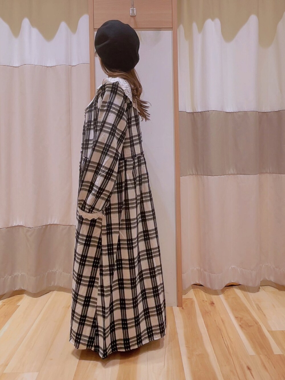 ブラック系のハンドバッグ、ホワイト系のワンピース、ブラック系のハットを着用したレディースの秋コーディネートの2枚目の写真