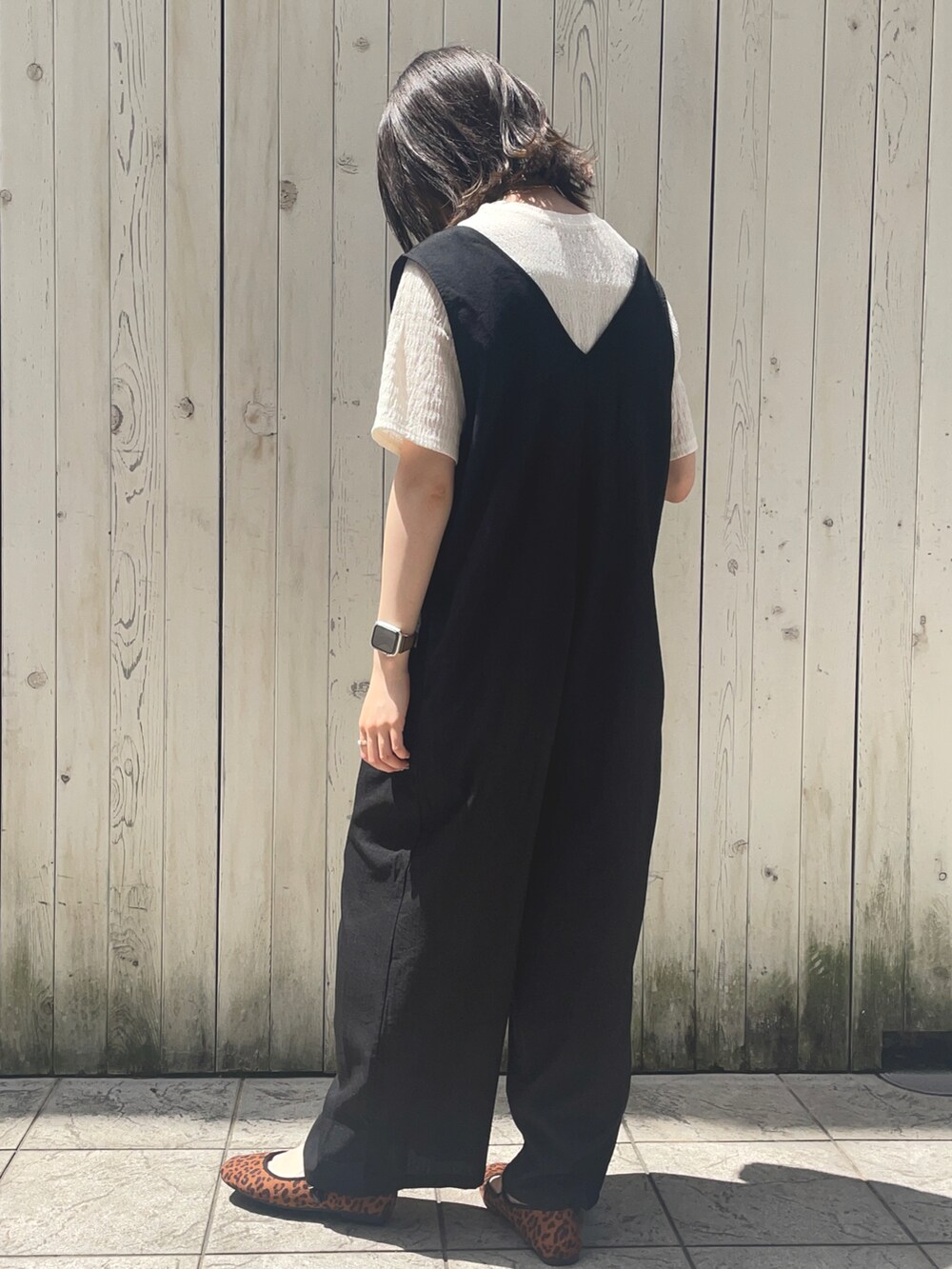 ブラック系のサロペット/オーバーオール、ホワイト系のTシャツ/カットソー、ブラウン系のドレスシューズを着用したレディースの夏コーディネートの2枚目の写真