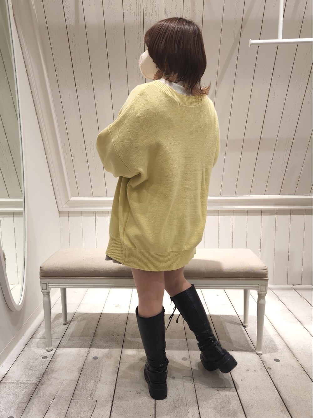 イエロー系のカーディガン/ボレロ、ベージュ系のスカート、ホワイト系のTシャツ/カットソーを着用したレディースの冬コーディネートの3枚目の写真