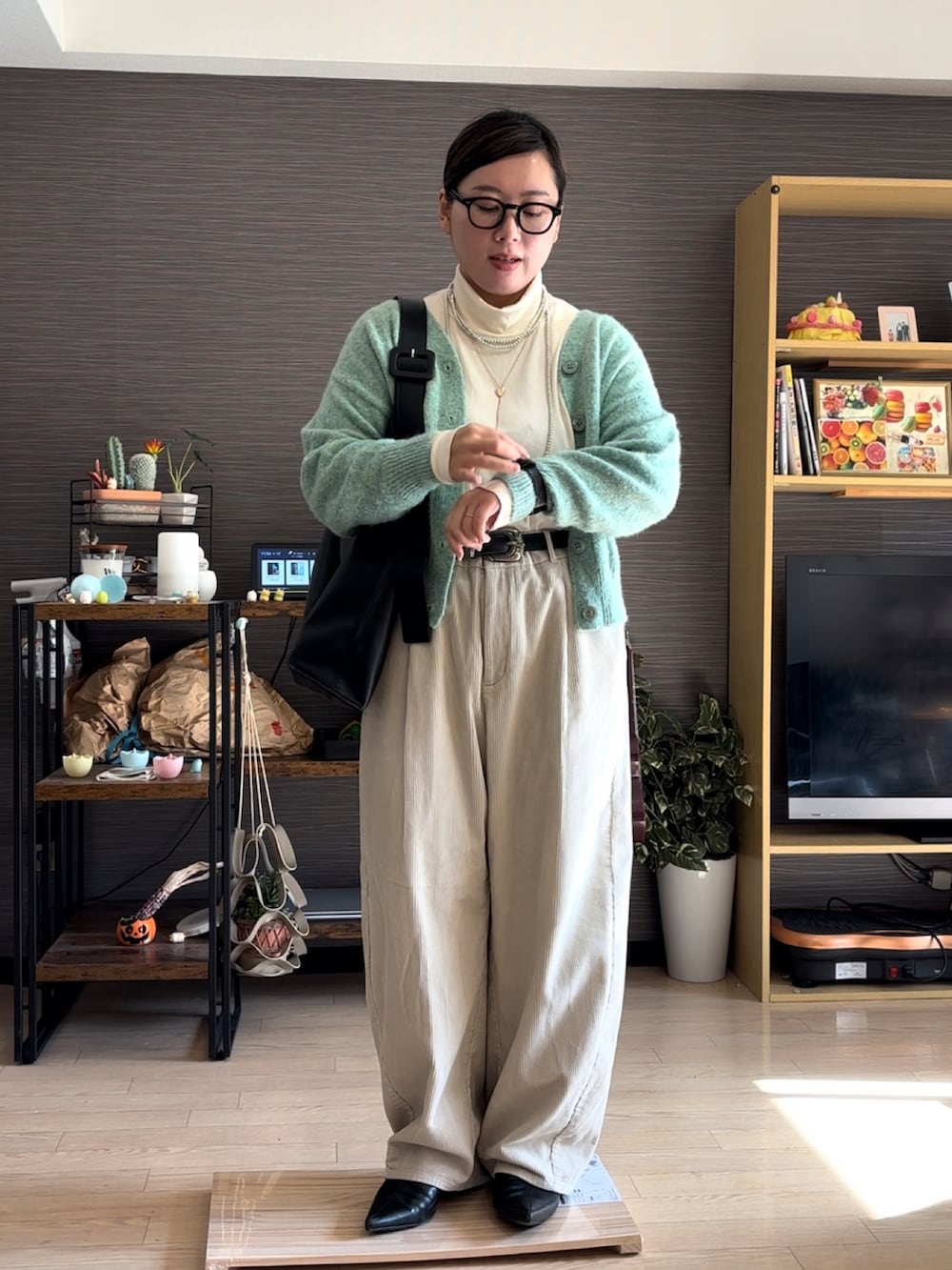 ホワイト系のパンツ、ブラック系のブーツ、ホワイト系のTシャツ/カットソーを着用したレディースの冬コーディネートの2枚目の写真