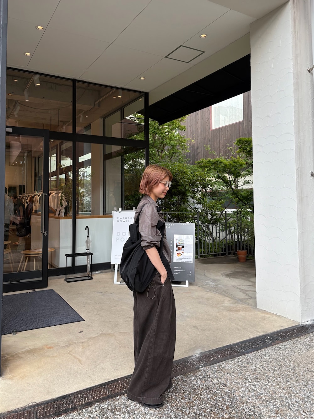 ブラウン系のその他パンツ、グレー系のブルゾン、レッド系のネックレスを着用したレディースの春コーディネートの2枚目の写真