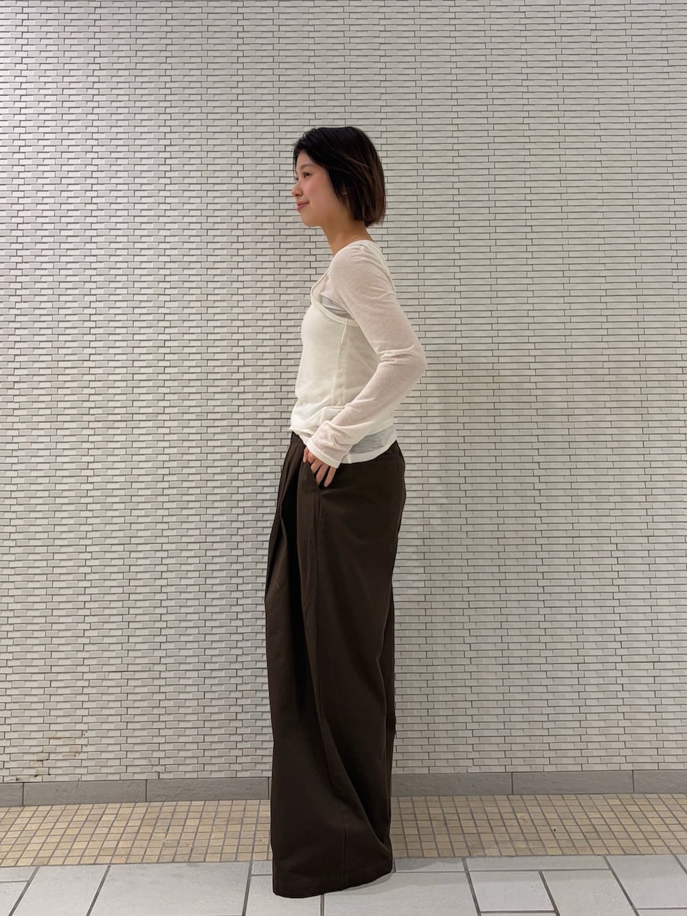 ホワイト系のTシャツ/カットソー、ブラウン系のその他パンツ、ブラウン系のスニーカーを着用したレディースの春コーディネートの3枚目の写真