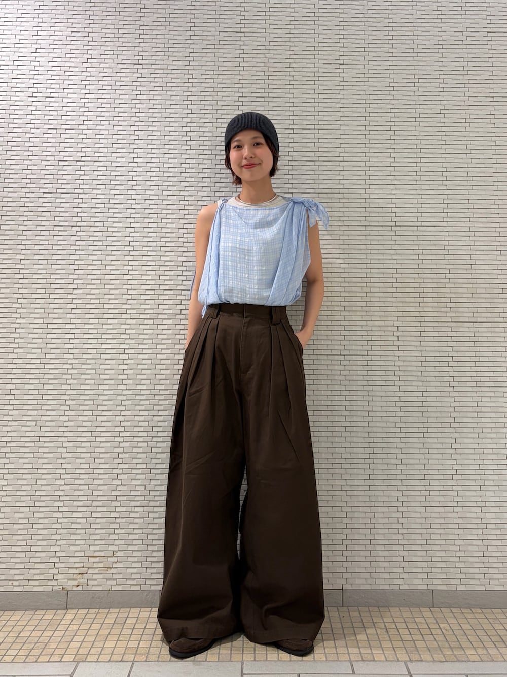 ブラウン系のその他パンツ、ブルー系のその他トップス、ベージュ系のタンクトップを着用したレディースの春コーディネートの2枚目の写真