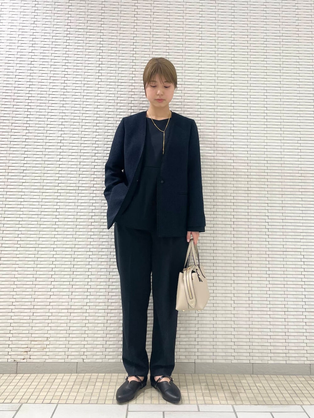 ブルー系のセットアップ、ブルー系のスーツジャケット、ブラック系のパンプスを着用したレディースの冬コーディネートの3枚目の写真