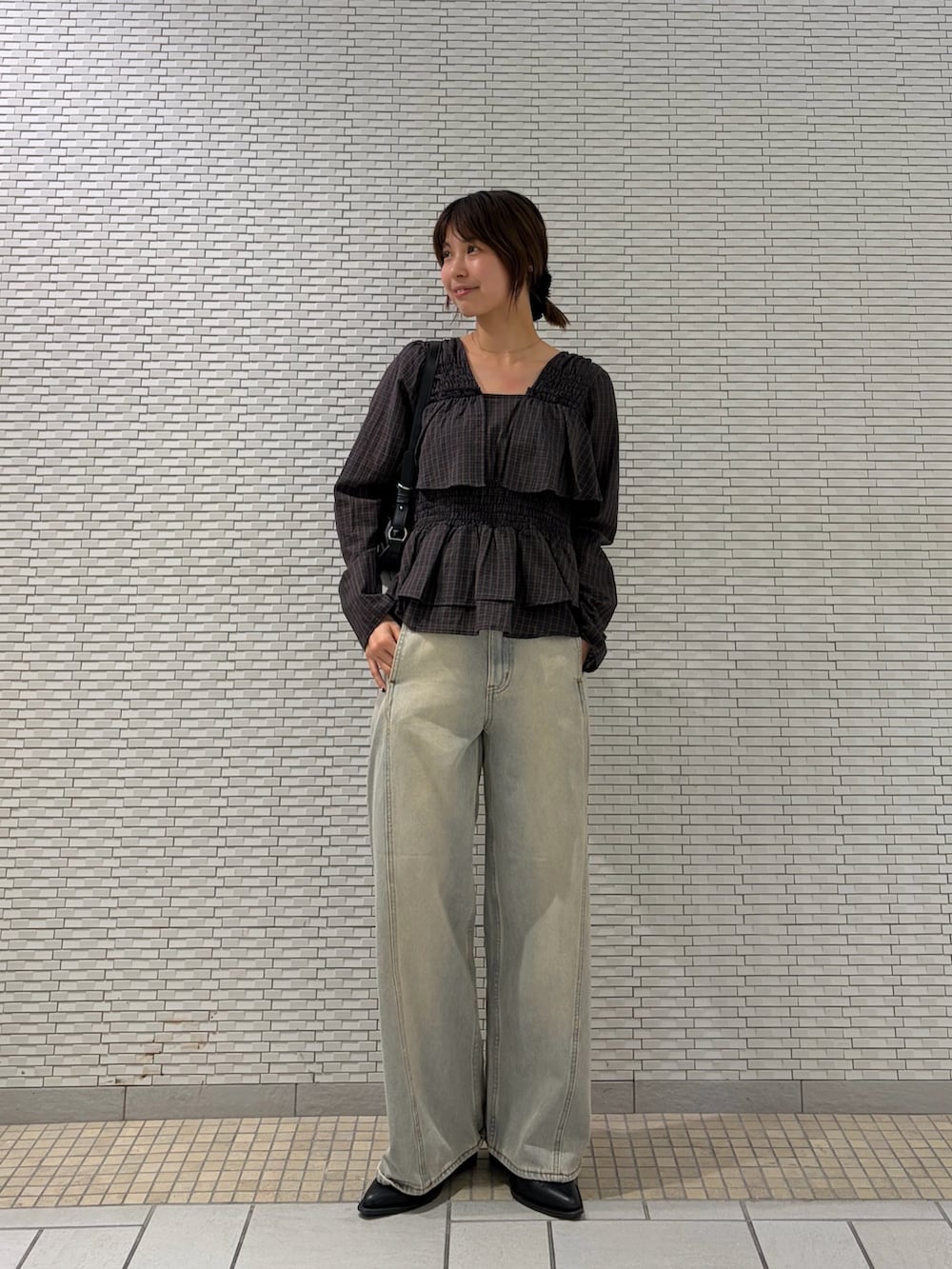 ブラウン系のシャツ/ブラウス、ブルー系のデニムパンツ、ブラック系のショルダーバッグを着用したレディースの秋コーディネートの4枚目の写真