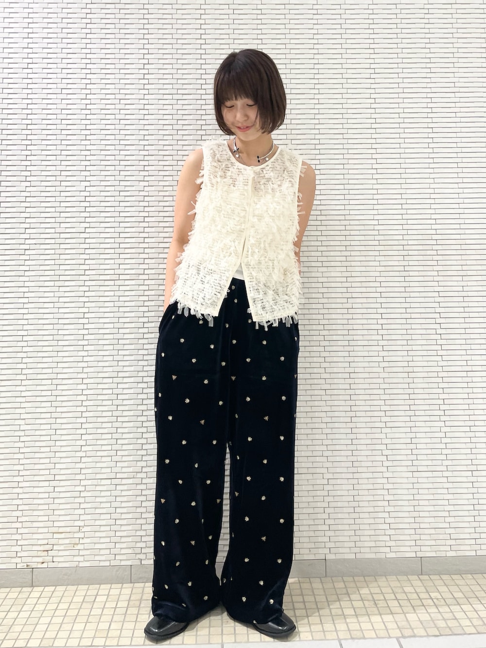 ブルー系のその他パンツ、ホワイト系のベスト、ブラック系のその他シューズを着用したレディースの秋コーディネートの2枚目の写真
