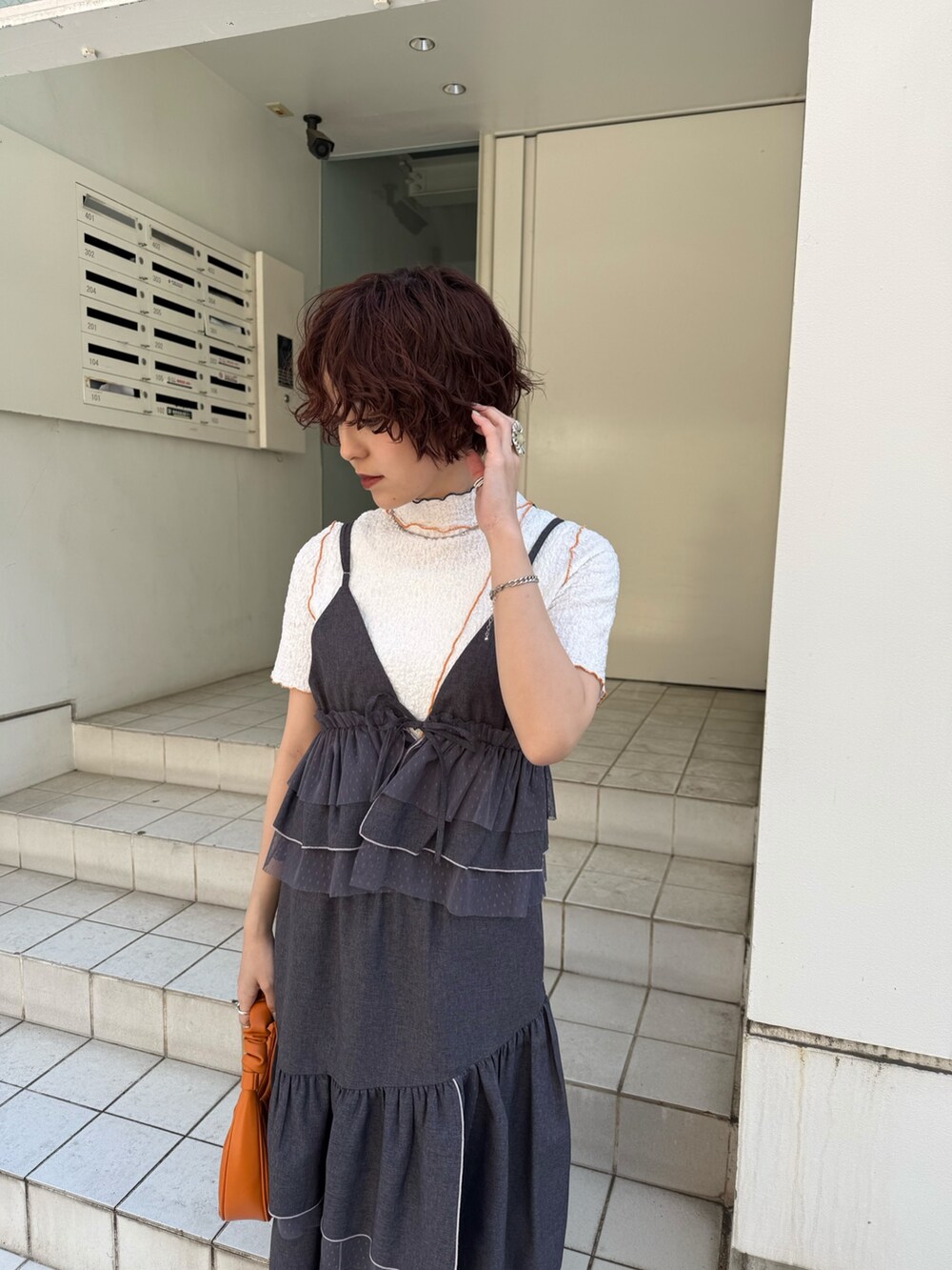 グレー系のスカート、グレー系のキャミソール、ホワイト系のTシャツ/カットソーを着用したレディースの春コーディネートの5枚目の写真