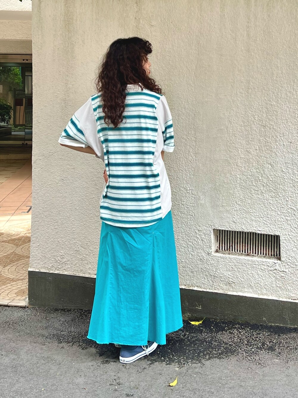 ホワイト系のTシャツ/カットソー、ブルー系のスカート、ブラック系のタンクトップを着用したレディースの春コーディネートの3枚目の写真