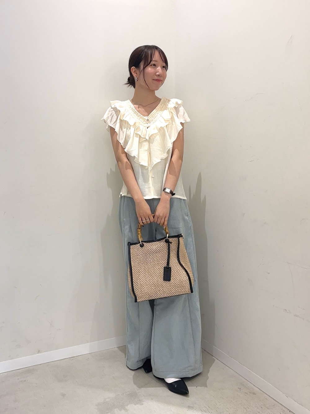 ホワイト系のシャツ/ブラウス、ブルー系のデニムパンツ、ブラック系のショルダーバッグを着用したレディースの春コーディネートの2枚目の写真
