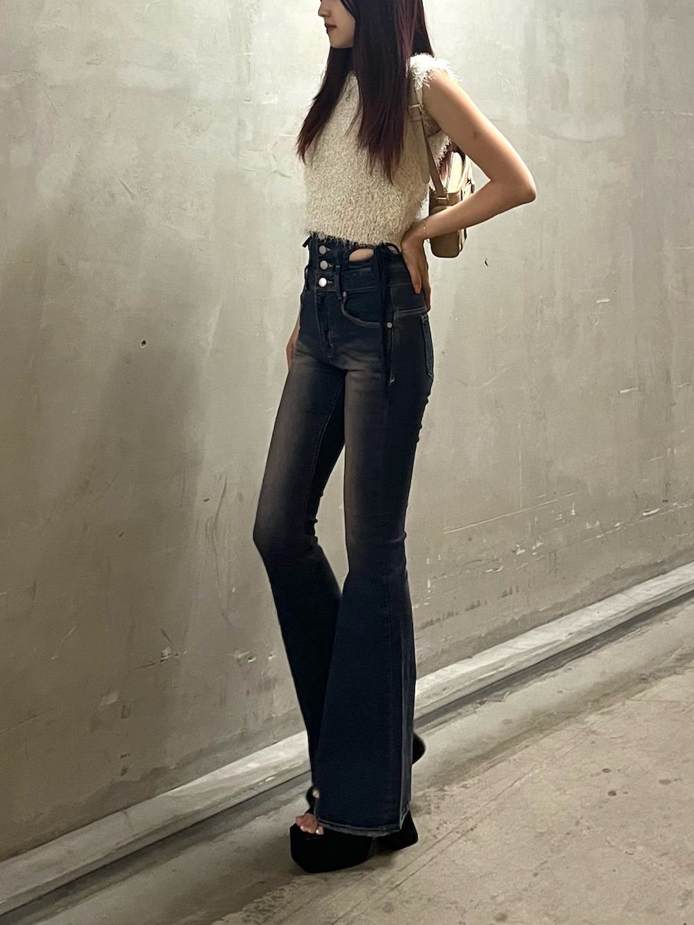 ブラック系のサンダル、ホワイト系のタンクトップ、ベージュ系のショルダーバッグを着用したレディースの夏コーディネートの2枚目の写真