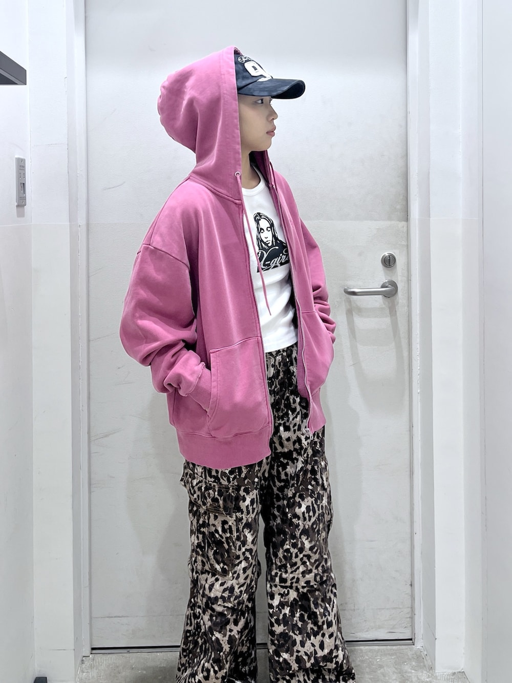 ピンク系のパーカー、ホワイト系のTシャツ/カットソー、ベージュ系のカーゴパンツを着用したレディースの冬コーディネートの3枚目の写真