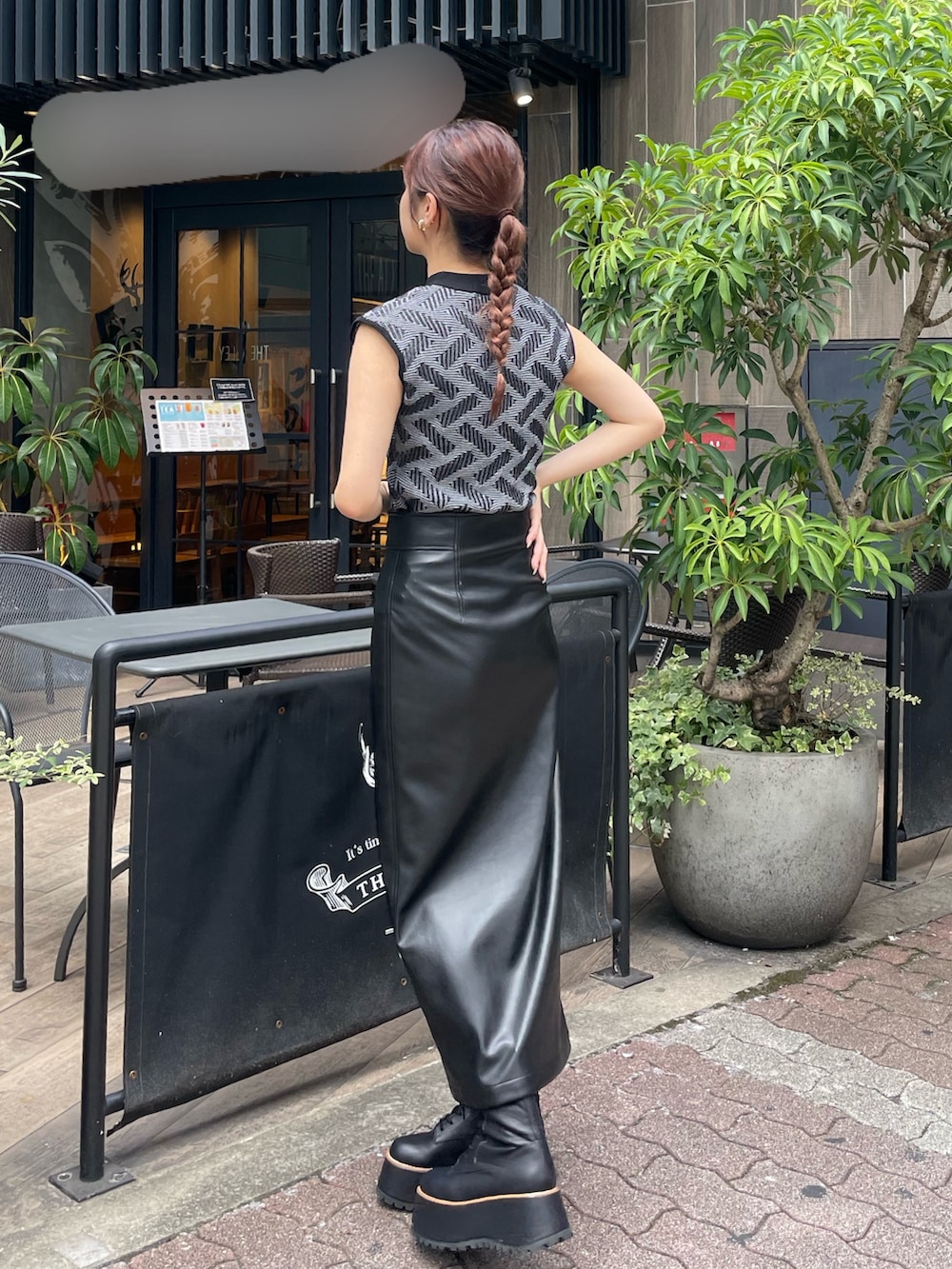 ブラック系のニット/セーター、ブラック系のスカート、ブラック系のブーツを着用したレディースの秋コーディネートの3枚目の写真