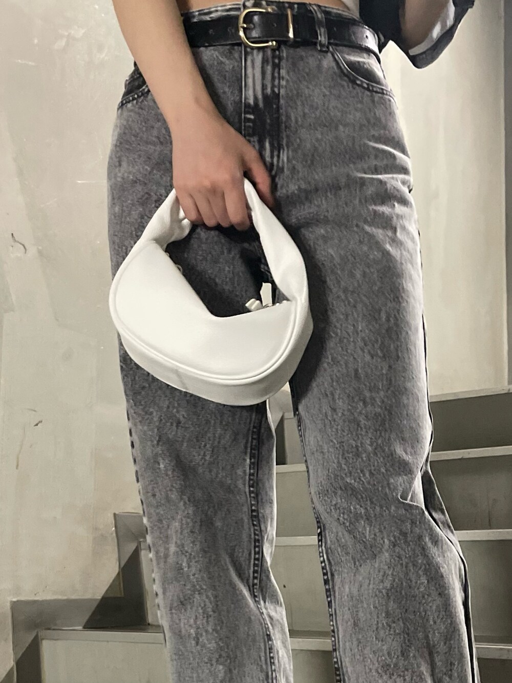 ホワイト系のTシャツ/カットソー、グレー系のデニムパンツ、ブラック系のサンダルを着用したレディースの春コーディネートの9枚目の写真