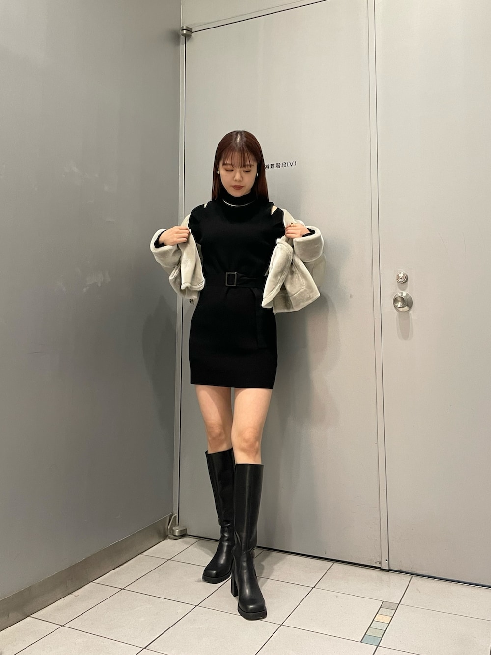 ブラック系のブーツ、ブラック系のワンピース、グレー系のムートンコートを着用したレディースの秋コーディネートの2枚目の写真