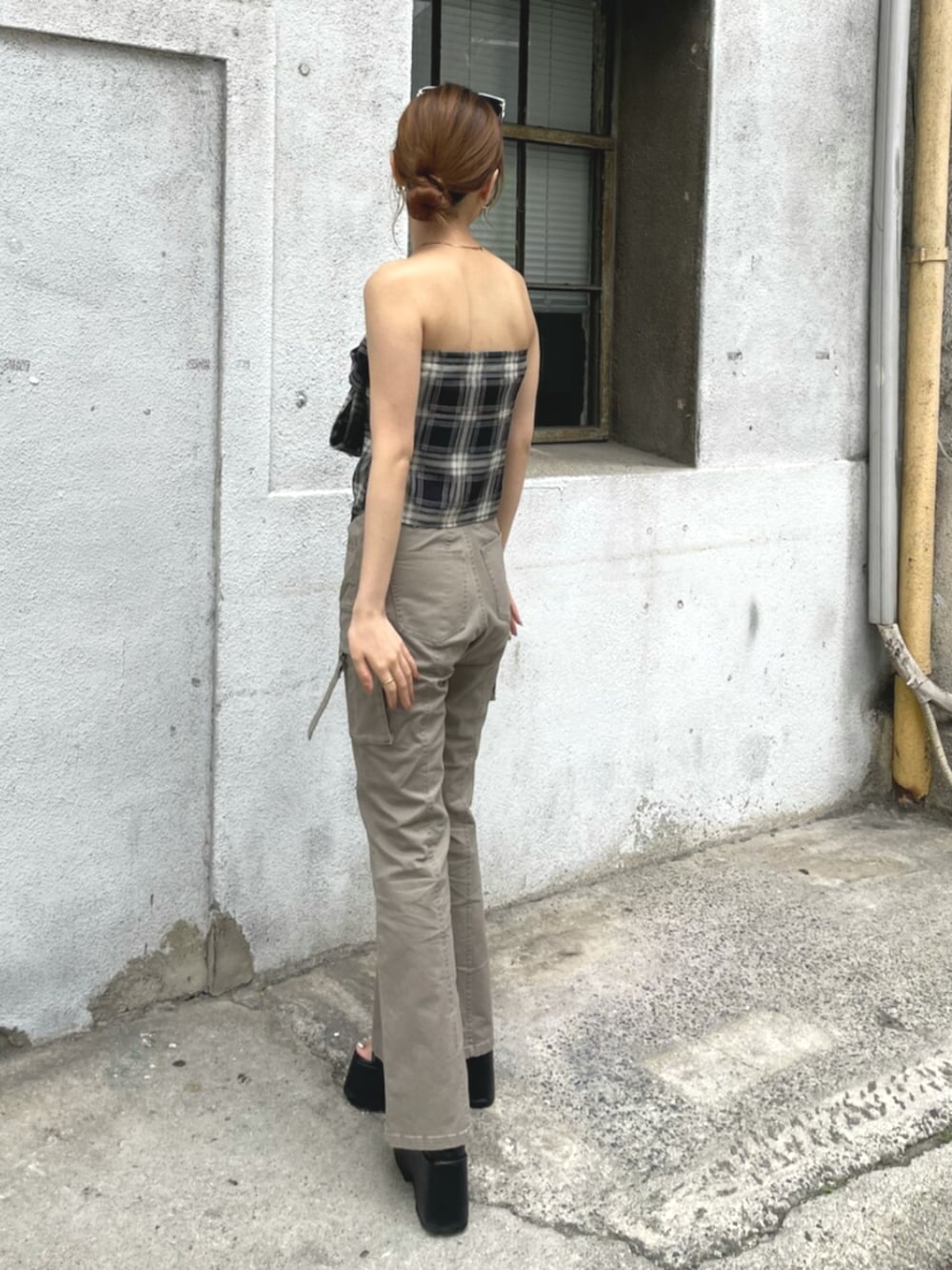 ベージュ系のカーゴパンツ、ブラック系のTシャツ/カットソー、ブラック系のブーツを着用したレディースの夏コーディネートの3枚目の写真