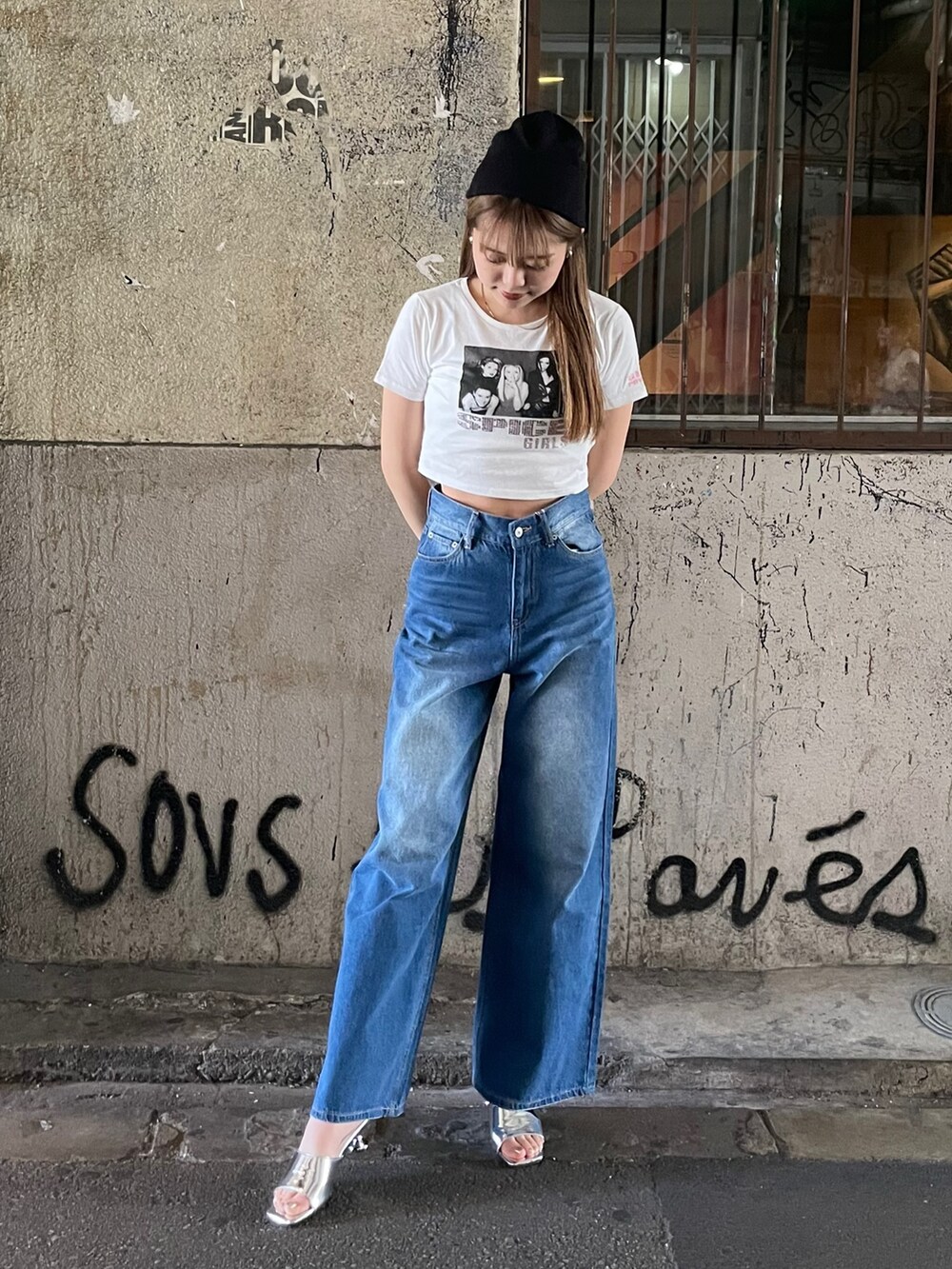 ブルー系のデニムパンツ、シルバー系のサンダル、ホワイト系のTシャツ/カットソーを着用したレディースの夏コーディネートの2枚目の写真