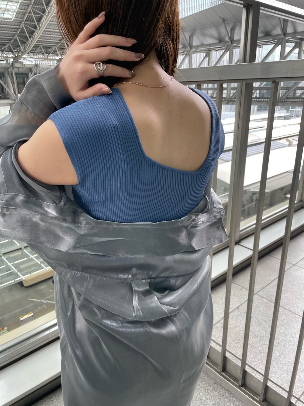 グレー系のシャツ/ブラウス、ブルー系のタンクトップ、ブラック系のハンドバッグを着用したレディースの春コーディネートの7枚目の写真