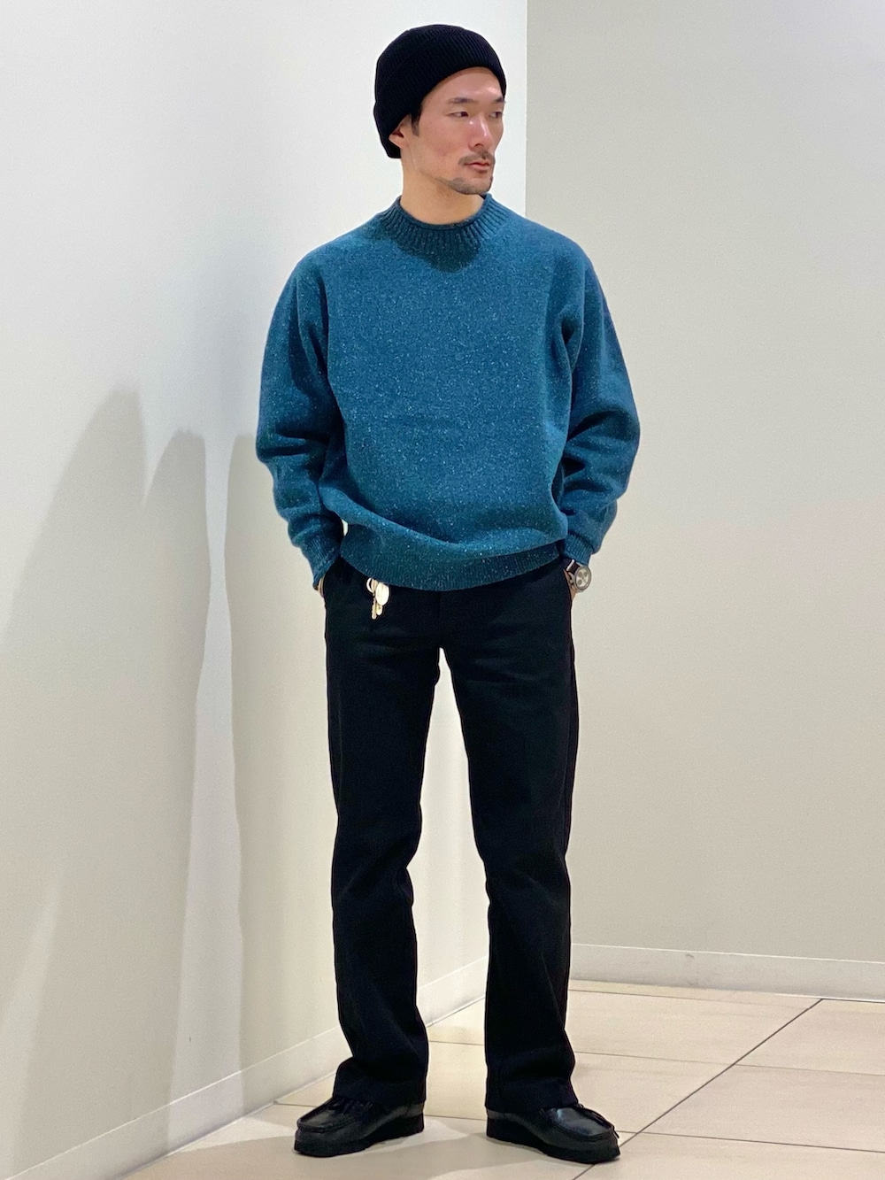 ホワイト系のダウンベスト、グリーン系のニット/セーター、グリーン系のマフラーを着用したメンズの冬コーディネートの6枚目の写真