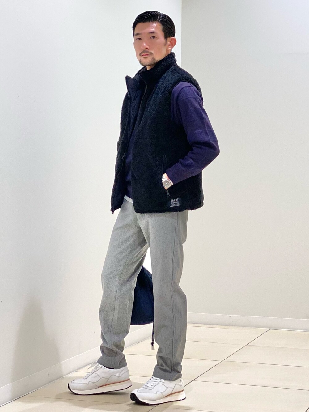 パープル系のニット/セーター、グレー系のその他パンツ、ホワイト系のスニーカーを着用したメンズの秋コーディネートの6枚目の写真