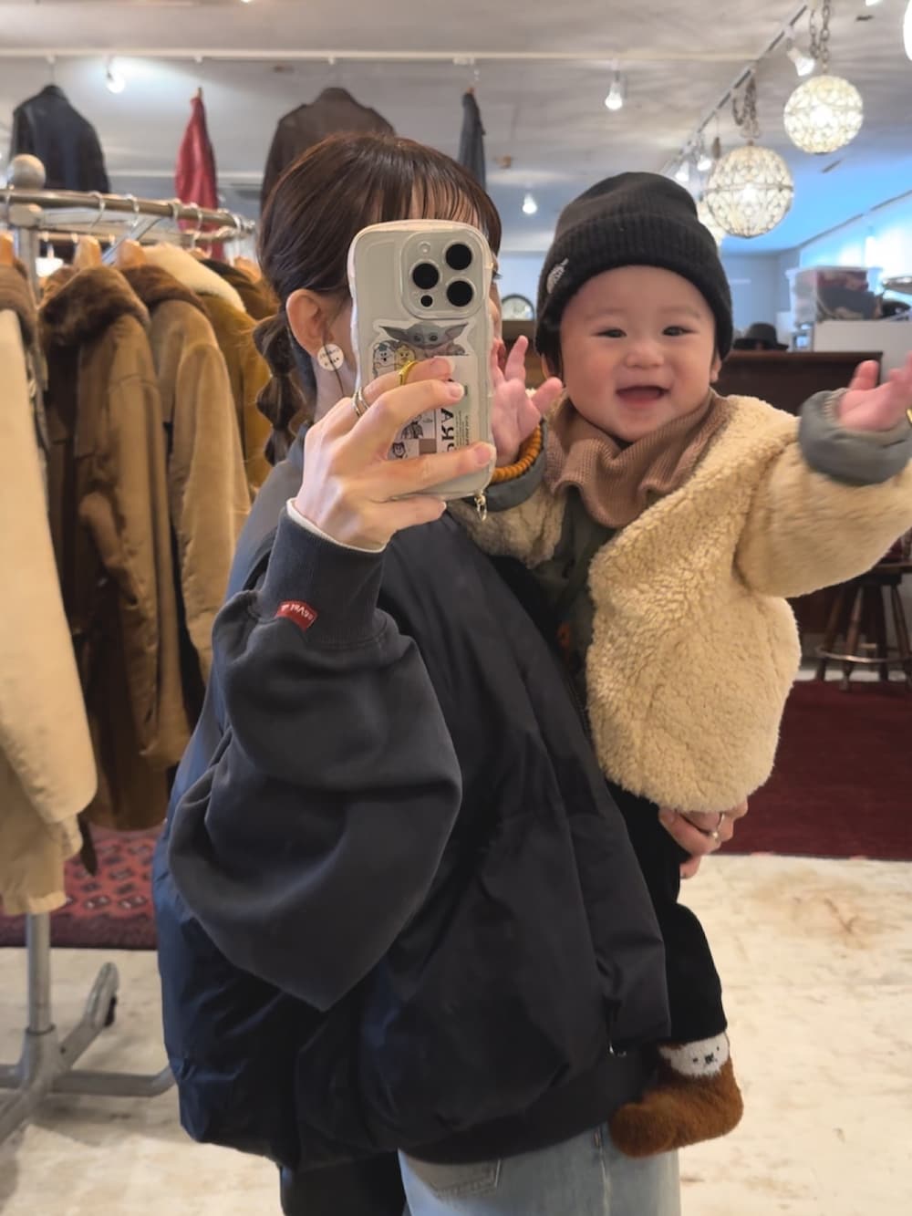 ブラック系のダウンベスト、グレー系のスウェット、ブルー系のデニムパンツを着用したレディースの冬コーディネートの4枚目の写真