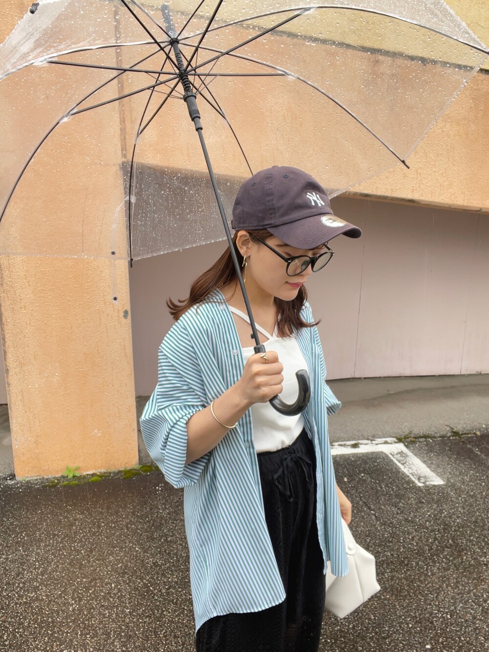 グリーン系のシャツ/ブラウス、ブラック系のその他パンツ、ホワイト系のキャミソールを着用したレディースの春コーディネートの2枚目の写真