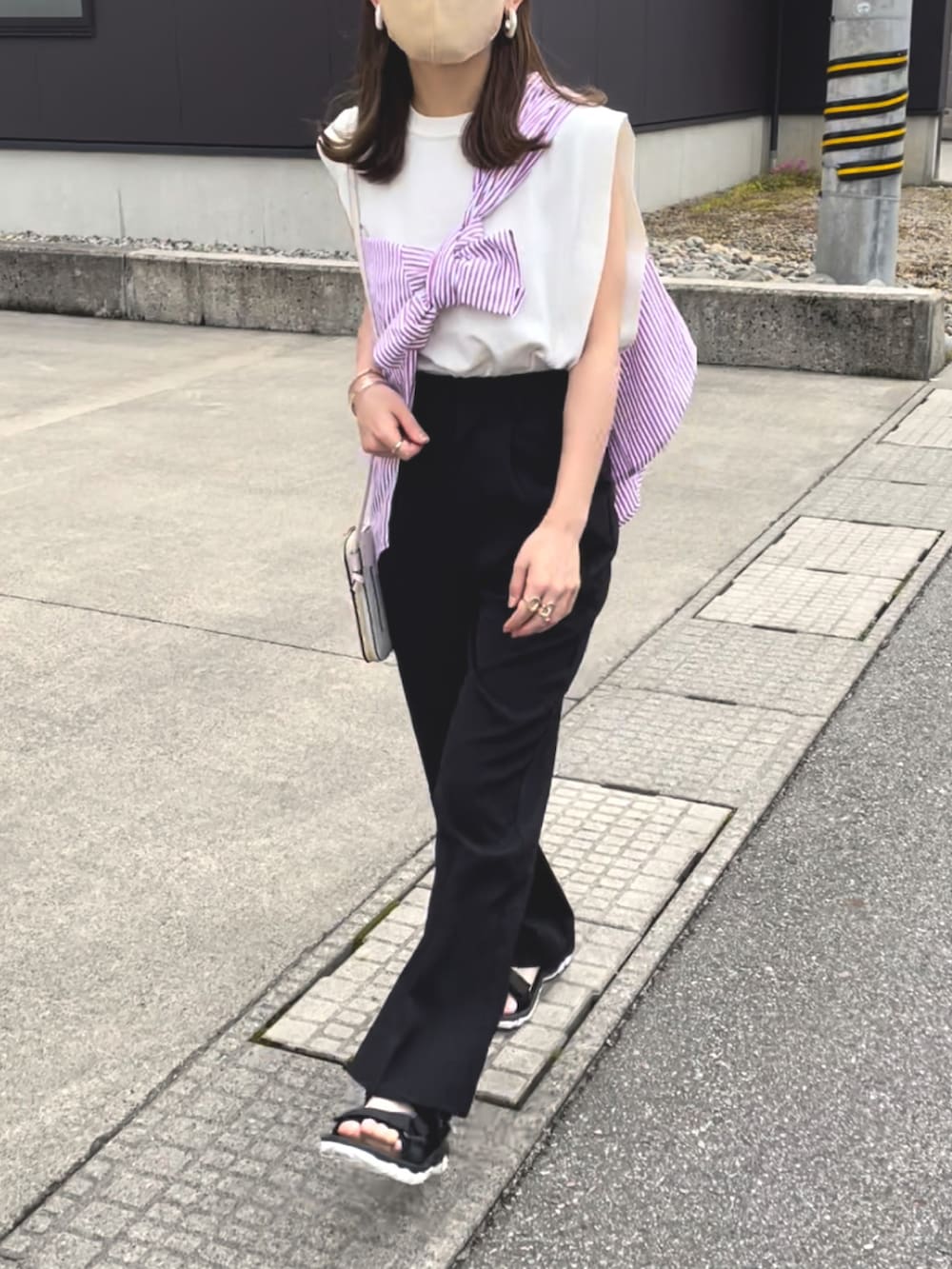 ピンク系のシャツ/ブラウス、ホワイト系のニット/セーター、ブラック系のスラックスを着用したレディースの夏コーディネートの3枚目の写真