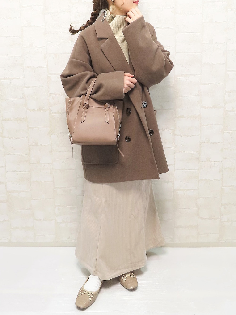 ブラウン系のその他アウター、ベージュ系のニット/セーター、ホワイト系のスカートを着用したレディースの秋コーディネートの3枚目の写真