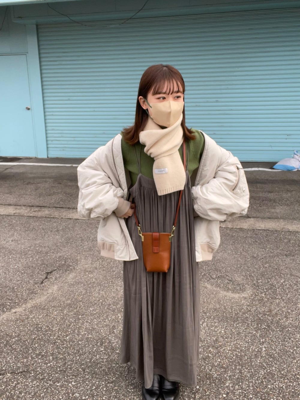 グリーン系のスカート、グリーン系のニット/セーター、グレー系のMA-1を着用したレディースの秋コーディネートの5枚目の写真