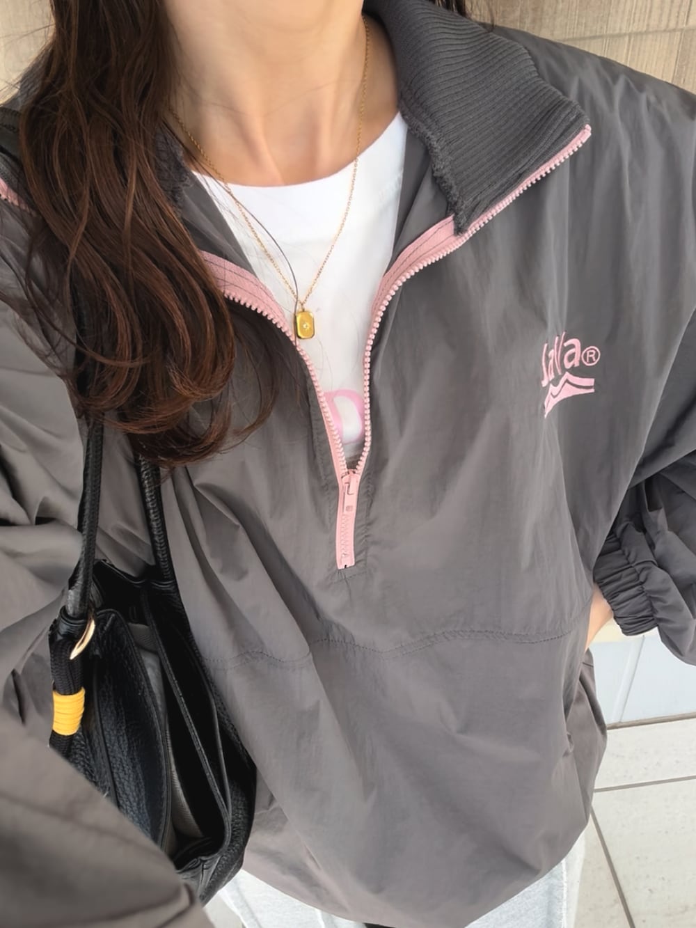 グレー系のブルゾン、グレー系のスウェットパンツ、ブラック系のスニーカーを着用したレディースの秋コーディネートの3枚目の写真