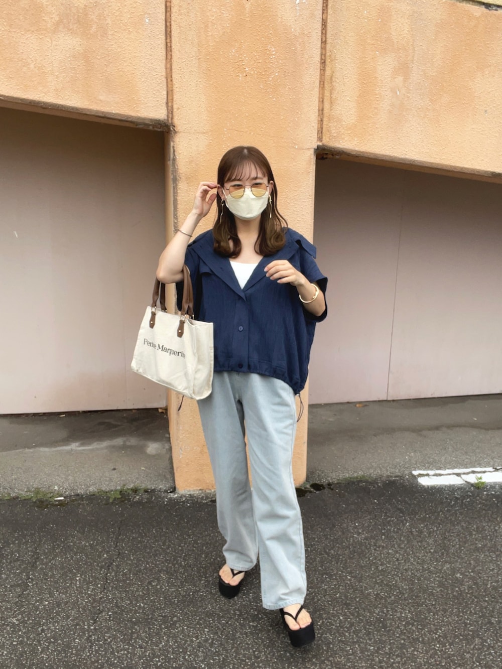 ブルー系のシャツ/ブラウス、ブルー系のデニムパンツ、ホワイト系のトートバッグを着用したレディースの夏コーディネートの2枚目の写真