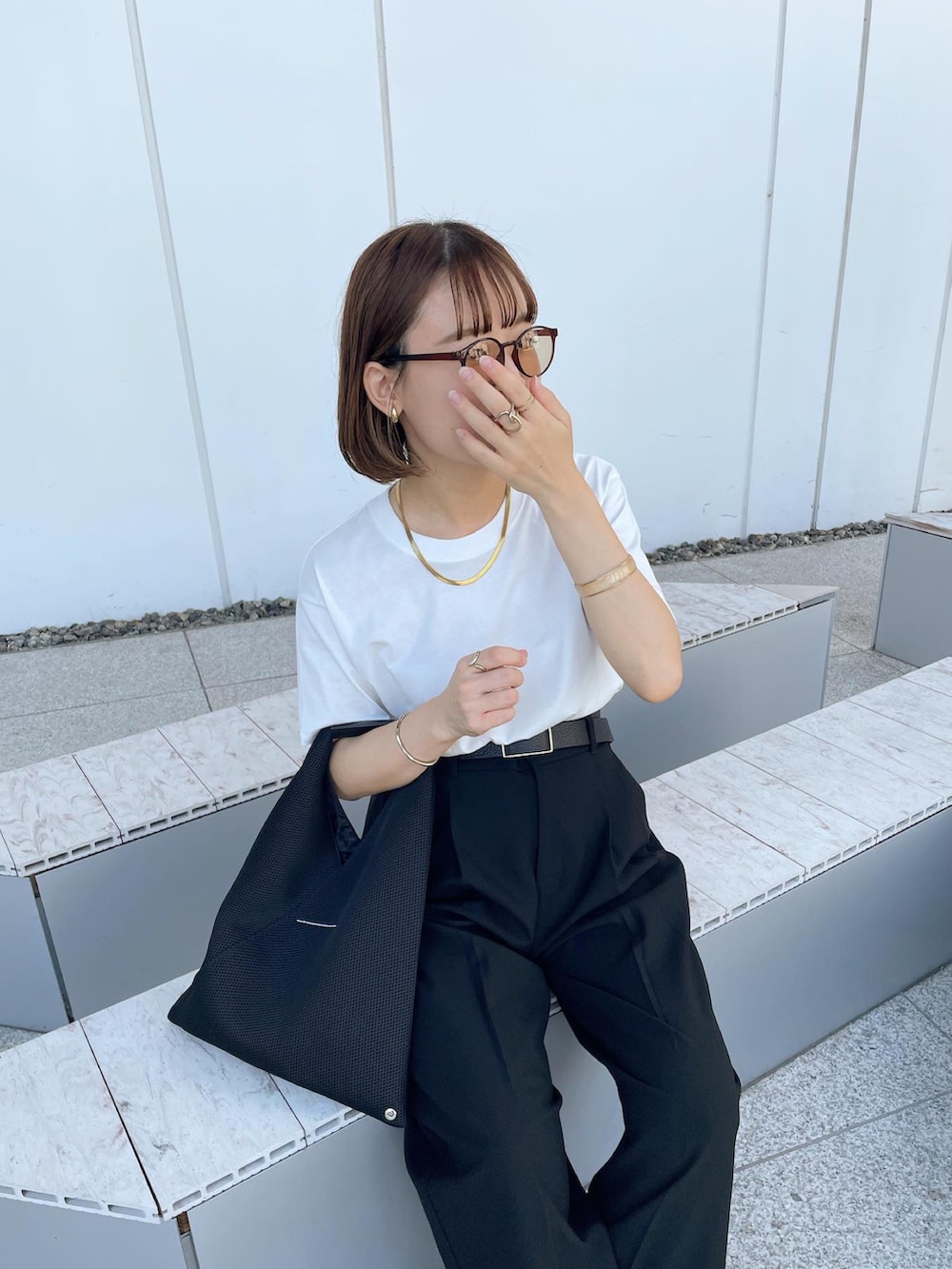 ホワイト系のTシャツ/カットソー、ブラック系のパンツ、ブラック系のトートバッグを着用したレディースの夏コーディネートの2枚目の写真