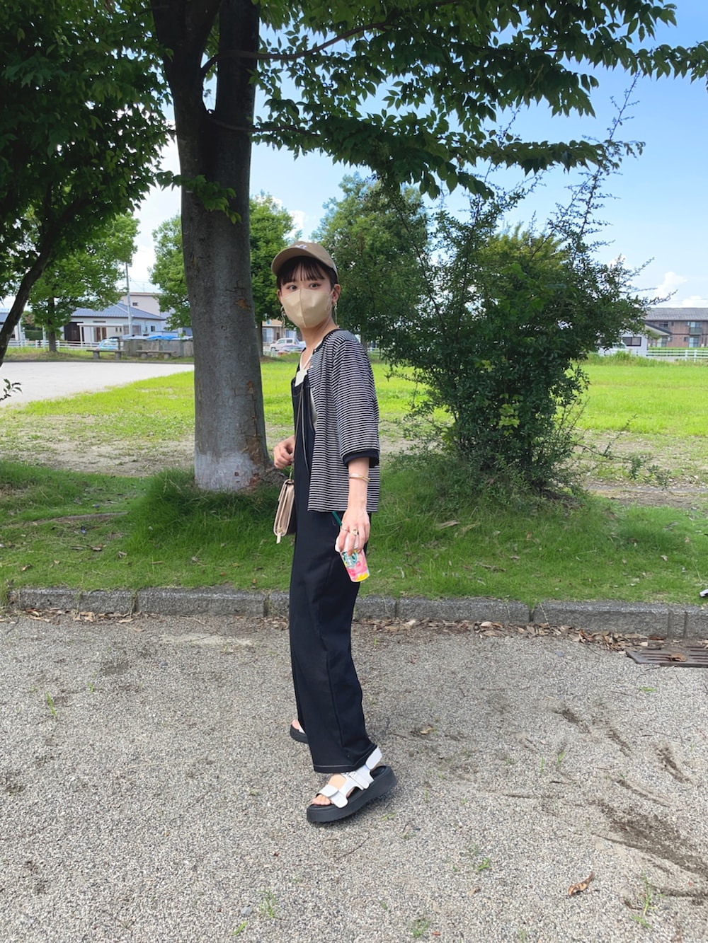 ブラック系のTシャツ/カットソー、ホワイト系のキャミソール、ブラック系のつなぎ/オールインワンを着用したレディースの夏コーディネートの5枚目の写真