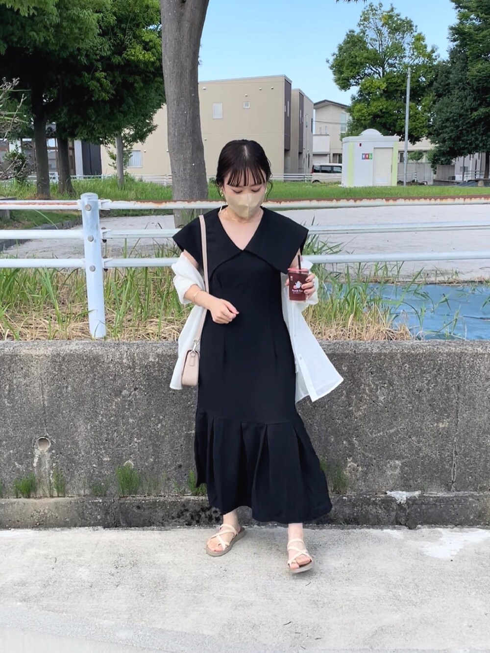 ブラック系のワンピース/ドレス、ベージュ系のショルダーバッグ、ホワイト系のシャツ/ブラウスを着用したレディースの夏コーディネートの5枚目の写真