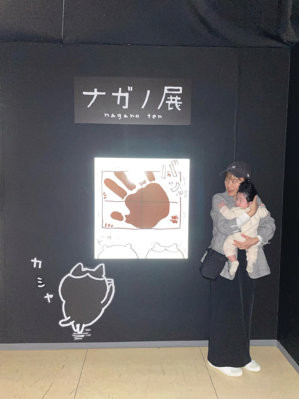 ブラック系のテーラードジャケット、ブラック系のワンピース、ホワイト系のスニーカーを着用したレディースの春コーディネートの3枚目の写真