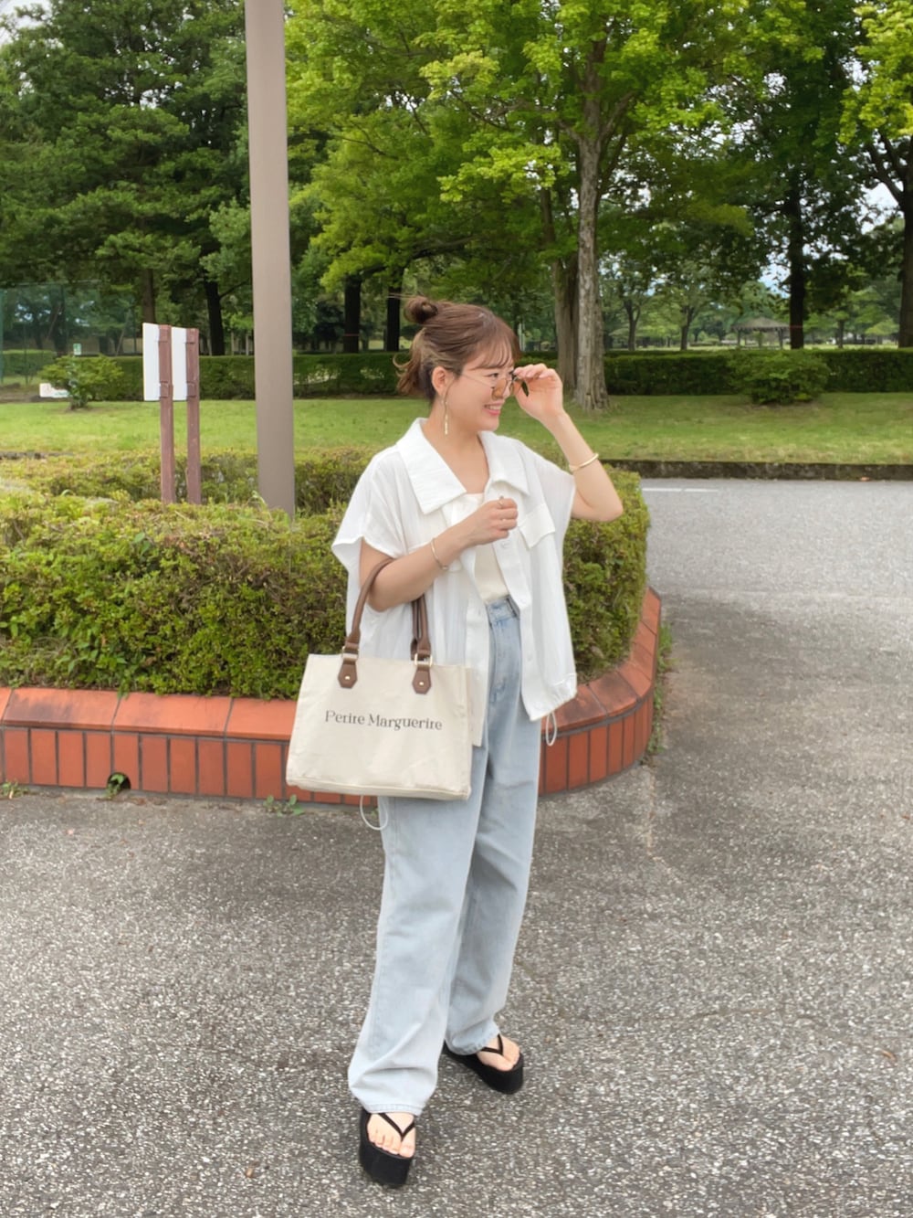 ホワイト系のシャツ/ブラウス、ブルー系のデニムパンツ、ホワイト系のトートバッグを着用したレディースの夏コーディネートの4枚目の写真