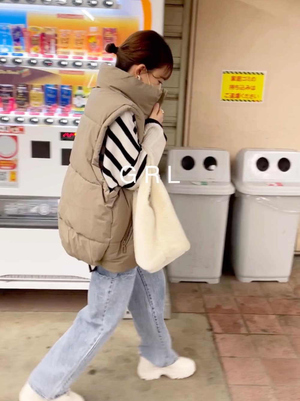 ホワイト系のニット/セーター、その他のデニムパンツ、ベージュ系のダウンベストを着用したレディースの冬コーディネートの5枚目の写真