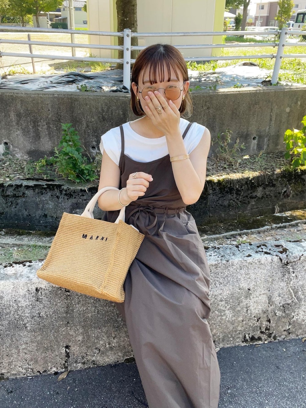 ブラウン系のワンピース/ドレス、ホワイト系のTシャツ/カットソー、ベージュ系のショルダーバッグを着用したレディースの夏コーディネートの5枚目の写真