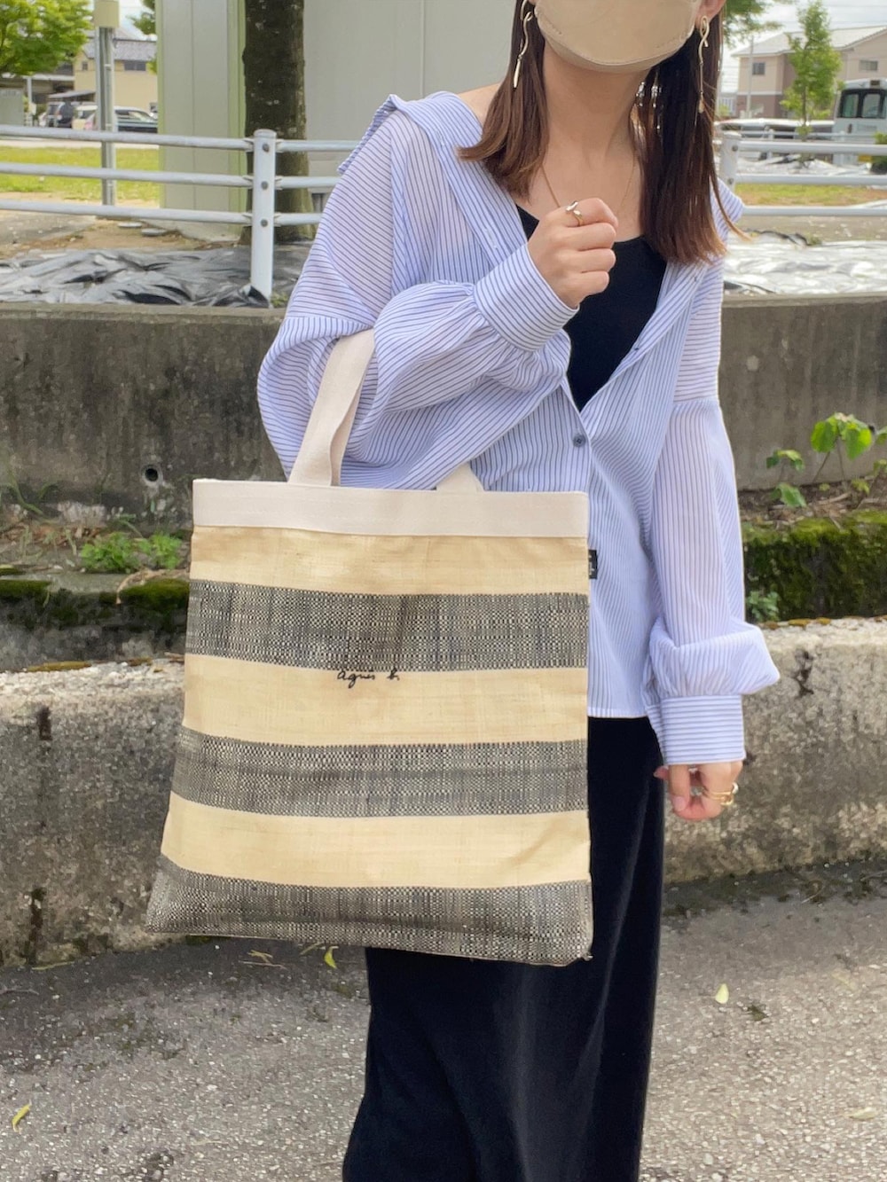 ブラック系のトートバッグ、ブルー系のシャツ/ブラウス、ブラック系のワンピースを着用したレディースの春コーディネートの3枚目の写真