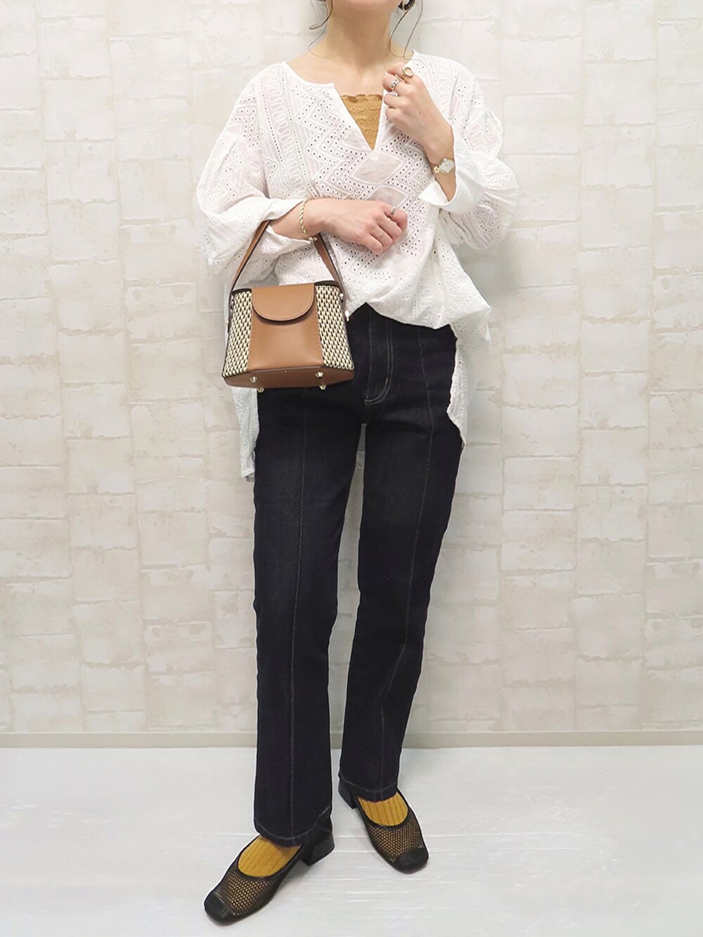 ホワイト系のシャツ/ブラウス、オレンジ系のキャミソール、イエロー系のショルダーバッグを着用したレディースの春コーディネートの3枚目の写真