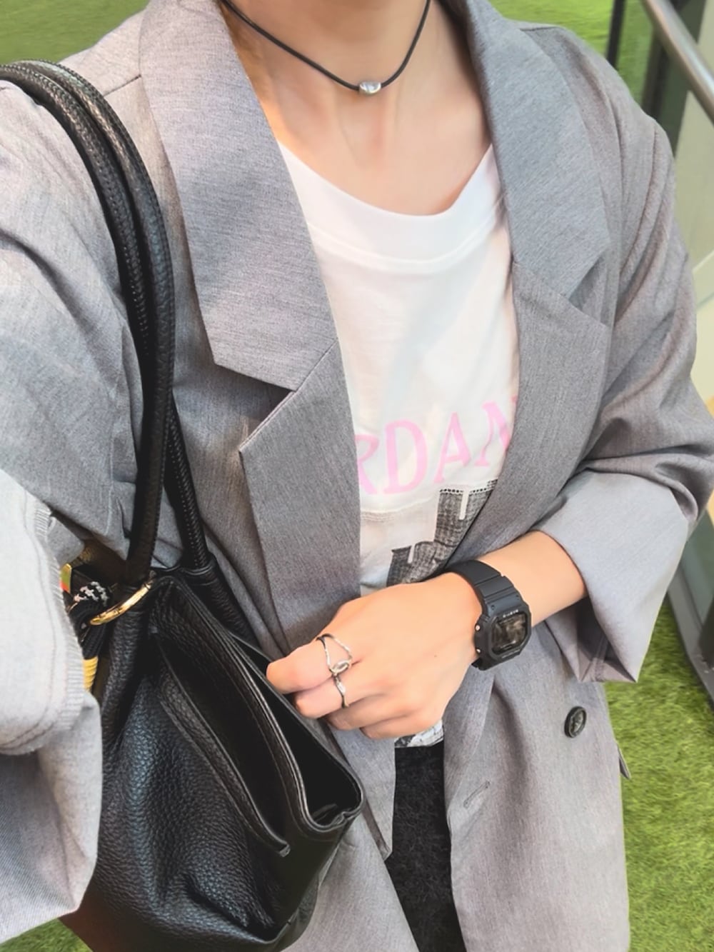 ホワイト系のTシャツ/カットソー、グレー系のテーラードジャケット、ブラック系のスカートを着用したレディースの秋コーディネートの2枚目の写真