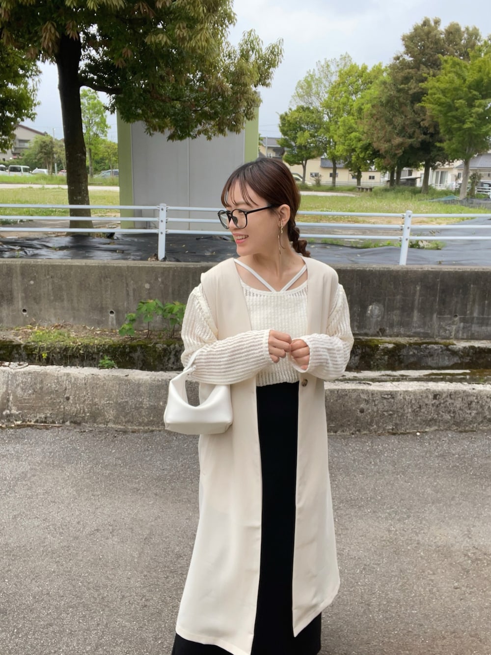 ホワイト系のベスト、ベージュ系のTシャツ/カットソー、ホワイト系のキャミソールを着用したレディースの春コーディネートの4枚目の写真