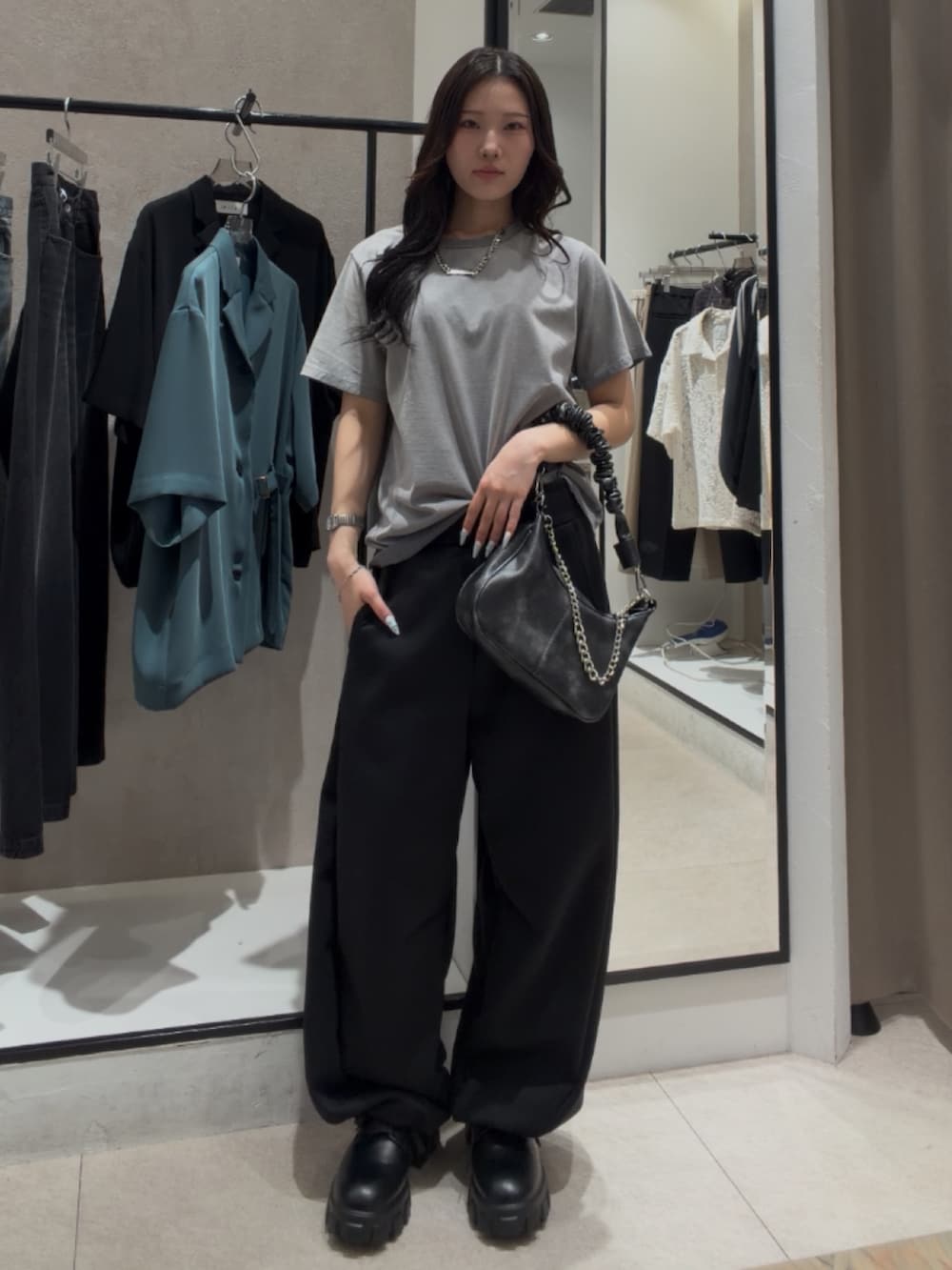 ブラック系のショルダーバッグ、ブラック系のその他シューズ、グレー系のTシャツ/カットソーを着用したレディースの春コーディネートの3枚目の写真