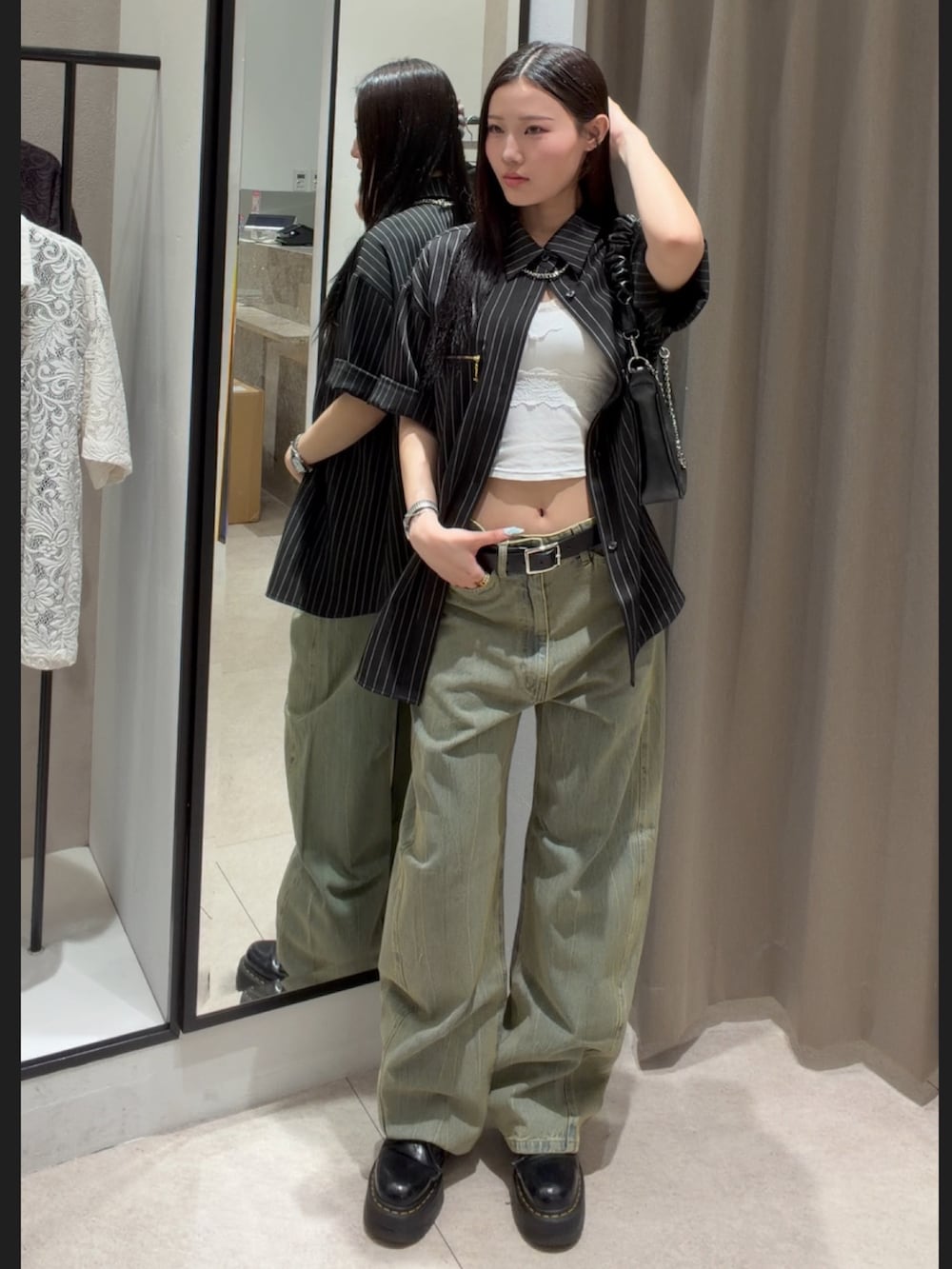 ブラック系のシャツ/ブラウス、グリーン系のデニムパンツ、ブラック系のショルダーバッグを着用したレディースの春コーディネートの4枚目の写真