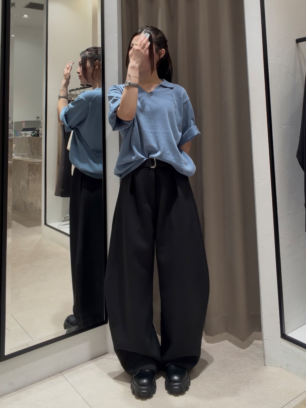 ブラック系のその他シューズ、ブラック系のスラックス、ブルー系のTシャツ/カットソーを着用したレディースの春コーディネートの3枚目の写真